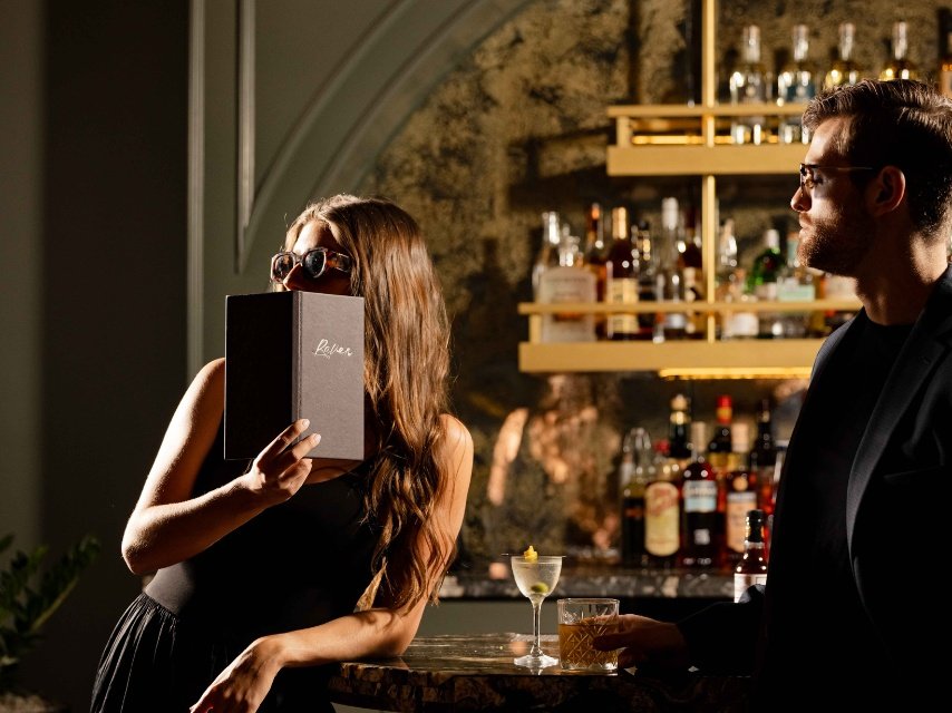 couple at the bar of Raven Speakeasy located inside Hotel Mockingbird in Dallas, TX